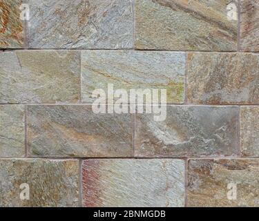 Exterior stone wall made with natural stone cladding Stock Photo