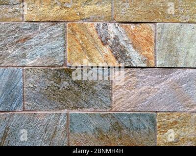 Exterior stone wall made with natural stone cladding Stock Photo