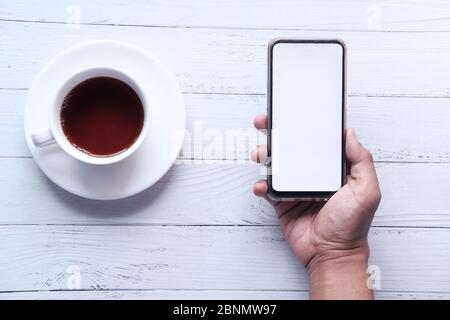 young man hand holding smart phone with empty screen  Stock Photo
