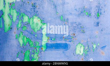 Old ragged cracked blue and green painted surface with rusty stains. Background texture, panoramic format, Stock Photo