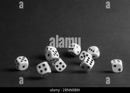 various tumbling dice on a black background in landscape format Stock Photo