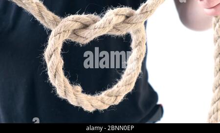 Person male hands tie a bowline knot in a piece of rope Stock Photo
