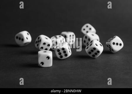 various tumbling dice on a black background in landscape format Stock Photo