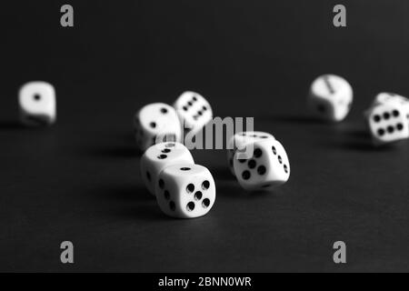 various tumbling dice on a black background in landscape format Stock Photo
