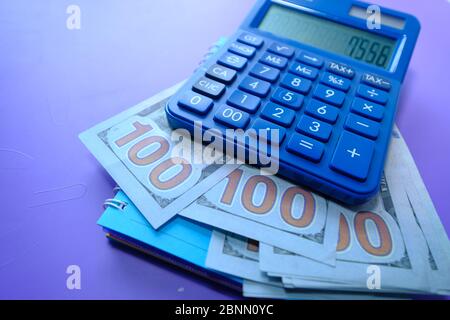 Close up of us dollar, calculator and notepad . Stock Photo