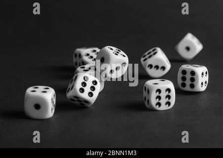 various tumbling dice on a black background in landscape format Stock Photo