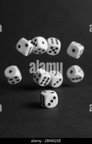 various tumbling dice on a black background in portrait format Stock Photo