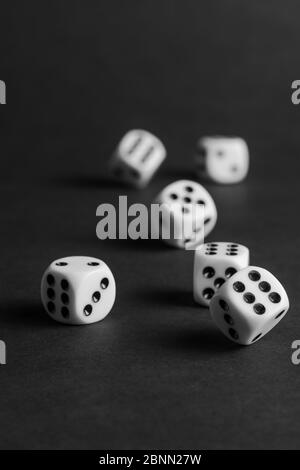 various tumbling dice on a black background in portrait format Stock Photo