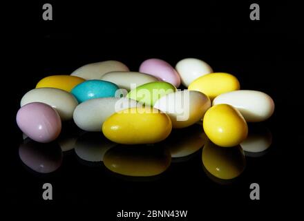 Multi colored candies isolated on black background Stock Photo