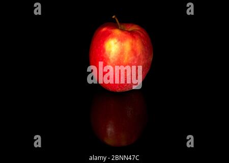 Red apple isolated on black background. Image of a fresh natural organic fruit. Stock Photo