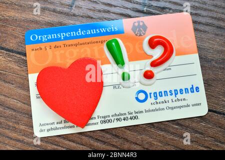 Organ donation card with heart, exclamation mark and question mark, consent for organ donation Stock Photo