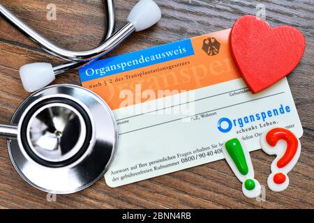 Organ donation card with stethoscope, heart, exclamation mark and question mark, consent for organ donation Stock Photo