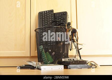 Office trash bin. Worn, computer components to be discarded. Stock Photo