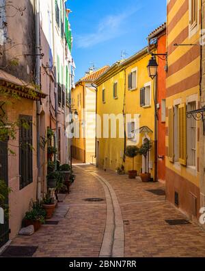 A pedestrian alleyway with colorful houses in the picturesque resort town of Cassis in  Southern France Stock Photo