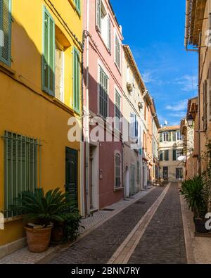 A pedestrian alleyway with colorful houses in the picturesque resort town of Cassis in  Southern France
