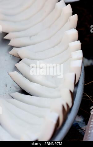 Coconut in shell halved halves, Morocco Stock Photo