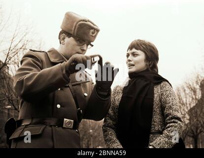 The border guard and the girl - hit star Mireille Mathieu with a border official of the GDR at the Checkpoint Charlie crossing in Berlin's Friedrichstrasse 1970 Stock Photo