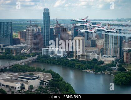 The U.S. Air Force Air Demonstration Squadron, the Thunderbirds fly in formation over downtown Austin, during the America Strong flyover May 13, 2020 in Austin, Texas. America Strong is a salute from the Navy and Air Force to recognize healthcare workers, first responders, and other essential personnel in a show of national solidarity during the COVID-19 pandemic. Stock Photo