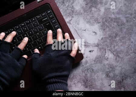 hacker hand stealing data from laptop at night  Stock Photo