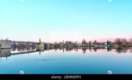 View over the Main to Heilig Kreuzkapelle, Kitzingen, Main, old Main Bridge, blue hour, Lower Franconia, Bavaria, Germany Stock Photo