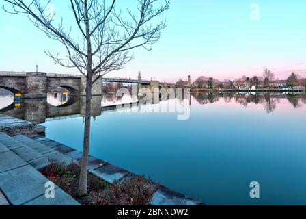 View over the Main to Heilig Kreuzkapelle, Kitzingen, Main, old Main Bridge, blue hour, Lower Franconia, Bavaria, Germany Stock Photo