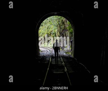 Hiker on train tracks that lead up to Aguas Calientes Stock Photo