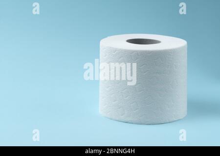 Toilet paper on blue background. Toilet paper roll tissue. Health care concept. Coronavirus panic concept. People are stocking up toilet paper for hom Stock Photo