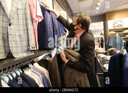 Ladue, United States. 15th May, 2020. Store manager Doug Winship places new spring sport coats on the rack at Mister Guy Clothiers in Ladue, Missouri on Friday, May 15, 2020. Stores in St. Louis County will reopen to the public on May 18, 2020, after being closed for two months because of the COVID-19 stay at home orders. Photo by Bill Greenblatt/UPI Credit: UPI/Alamy Live News Stock Photo