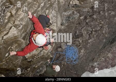 female climber climbing sea cliff in Swanage / England Stock Photo