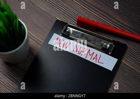 New Normal write on paperwork isolated on wooden table. Stock Photo