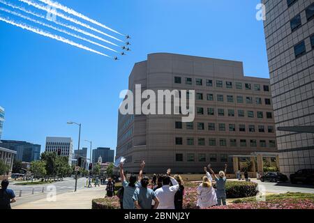 Los Angeles, California, USA. 15th May, 2020. The US Air Force Thunderbirds soars over Westwood in a salute to healthcare workers, first responders and other essential workers on the front lines during the coronavirus pandemic. Six F-16C/D Fighting Falcons flew in precision formation past hospitals and medical centers in L.A., Orange, Riverside and San Diego counties throughout the afternoon. Credit: Jason Ryan/ZUMA Wire/Alamy Live News Stock Photo