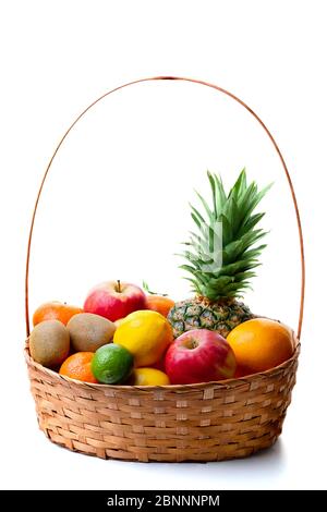 Basket with exotic fruits, pineapple, lime, lemon, mandarin, orange, kiwi, tangerines, grapefruit isolated over white background. Stock Photo