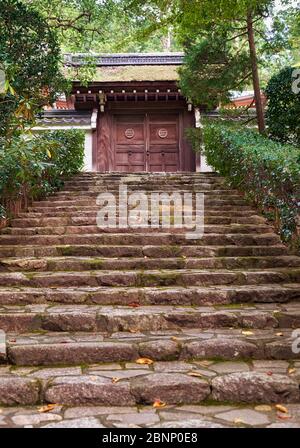 The stone steps leading through the forest to the rear entrance of the Ryoan-ji temple (Temple of the Dragon at Peace). Kyoto. Japan Stock Photo