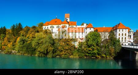 Former monastery of Sankt Mang and the Hohe Schloss over the river Lech, Füssen, Ostallgäu, Allgäu, Swabia, Bavaria, Germany, Europe Stock Photo