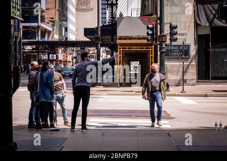 Chicago, USA. 15th May, 2020. Tourists, some wearing protective masks, pose for photos on State Street on Friday May 15, 2020 in Chicago, IL. (Photo by Christopher Dilts/Sipa USA) Credit: Sipa USA/Alamy Live News Stock Photo