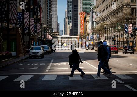 Chicago, USA. 15th May, 2020. Pedestrians wearing protective face masks cross State Street on Friday May 15, 2020 in Chicago, IL. (Photo by Christopher Dilts/Sipa USA) Credit: Sipa USA/Alamy Live News Stock Photo