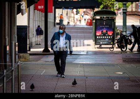 Chicago, USA. 15th May, 2020. A pedestrian wearing a protective mask walks down State Street on Friday May 15, 2020 in Chicago, IL. (Photo by Christopher Dilts/Sipa USA) Credit: Sipa USA/Alamy Live News Stock Photo