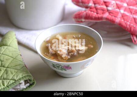 Chinese traditional american ginseng soup served in a bowl. Isolated. Stock Photo