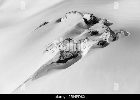 Switzerland, Graubünden, Samnaun, rocks in snow-covered winter landscape Stock Photo