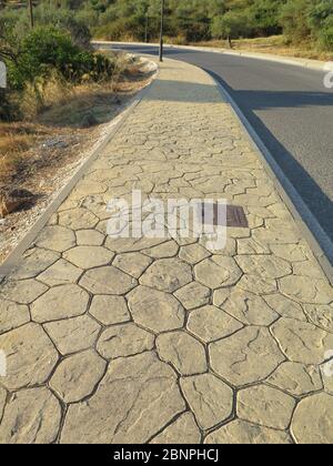 Patterned Pavement Slabs in urban road in Andalusian village Stock Photo