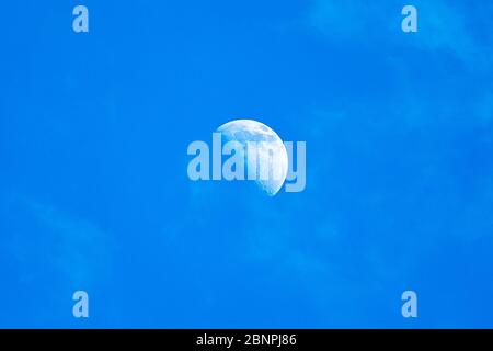 moon day field. moon in a blue cloudless sky Stock Photo