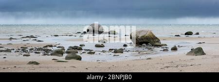 Panorama, sandy beach with boulders, stones on the beach of the Baltic Sea, cloudy sky and rain showers, stormy sea, near Wismar, Mecklenburg-West Pomerania, Germany Stock Photo