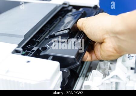 Technicians replacing toner in laser printer concept office supplies repair Stock Photo