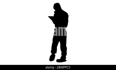 Silhouette Healthcare worker wearing hazmat suit working on digital tablet. Stock Photo