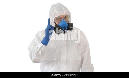 Doctor wearing hazard suit pointing with finger up wanting your attention on white background. Stock Photo