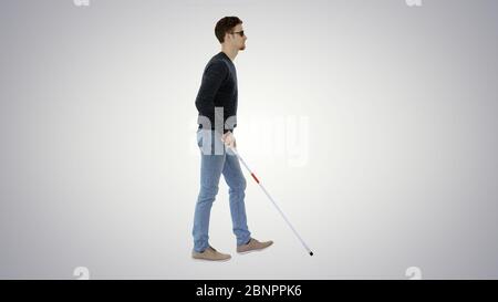 Young blind person with long cane and medical mask walking on white  background Stock Photo - Alamy