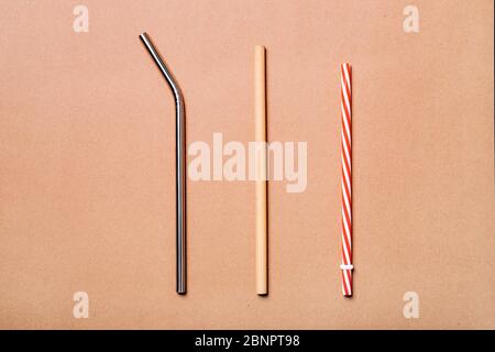 Different kinds of straws. Reusable bamboo, stainless steel and single-use plastic. Zero-waste, sustainability concept. Stock Photo