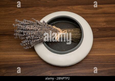 lavender in a round vase on wooden table Stock Photo