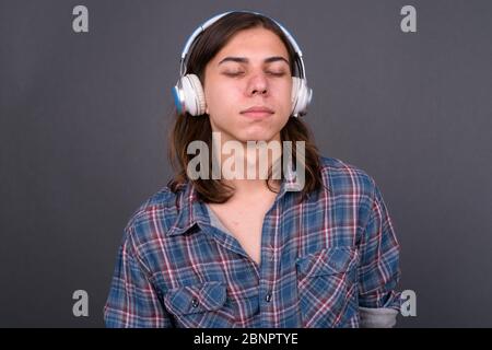 Young handsome hipster man with long hair Stock Photo