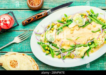 Chickpeas hummus with cabbage, asparagus, peas and microgreens.Oriental food. Stock Photo